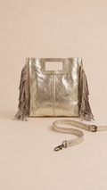 Bolso Aurea de piel dorada con flecos decorativos, asa corta y asa larga cruzada