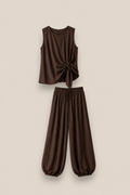 Conjunto SORA en color marron chocolate: top sin mangas con lazada lateral y pantalón bombacho de tela fluida. Talla única S-XL.