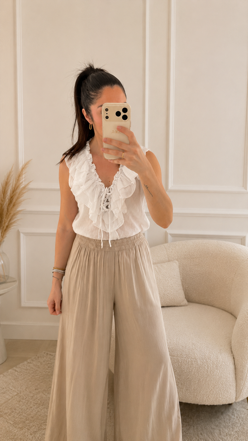 Modelo con Blusa Roma blanca de volantes y escote en V con lazo, confeccionada en 100% algodón
