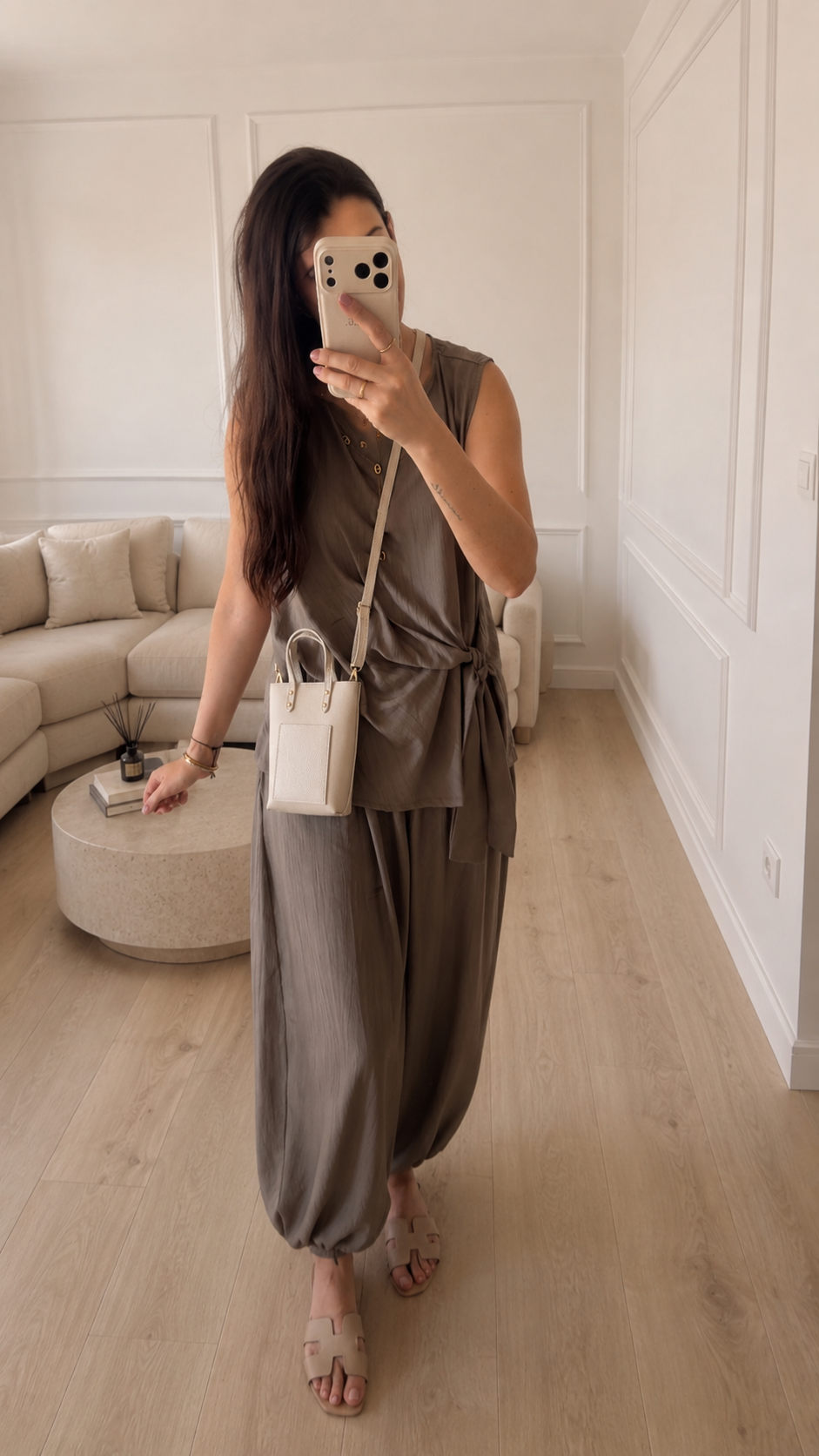 Modelo con Conjunto SORA taupe en look casual de día: top sin mangas con lazada y pantalón bombacho de tela fluida.