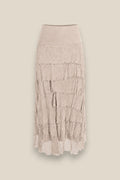 Falda de seda natural beige con capas de volantes y borde con flecos